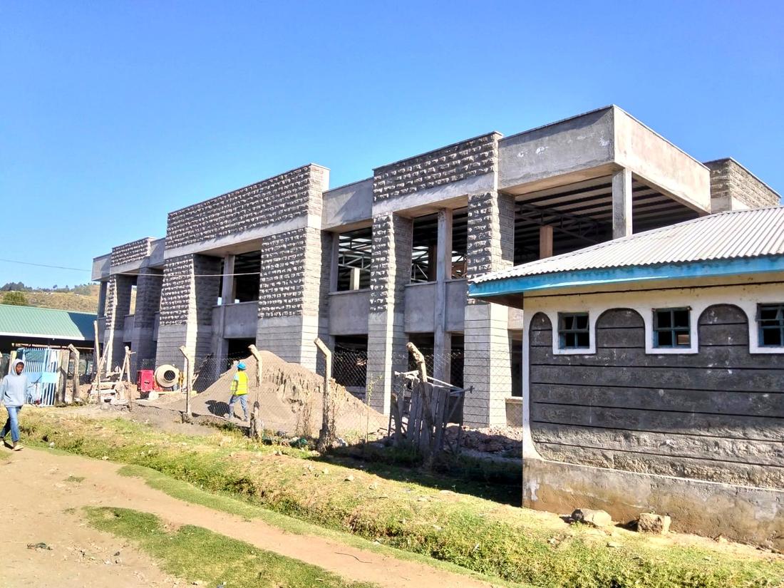 Stone-clad building under construction