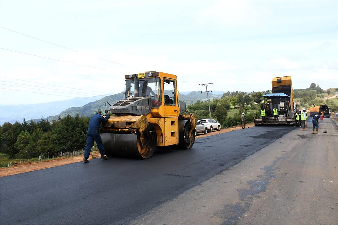 Road paving crew laying fresh asphalt